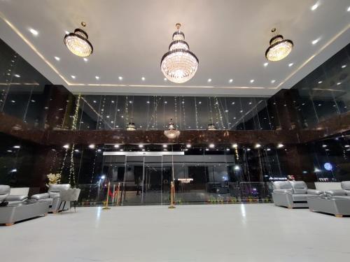 a large room with white chairs and a stage at Royal Bliss in Patna
