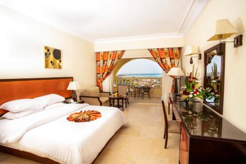 a hotel room with a bed and a living room at AMC Royal Hotel & Spa in Hurghada