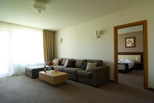 a living room with a couch and a table at Belchin Garden SPA&Wellness in Belchin