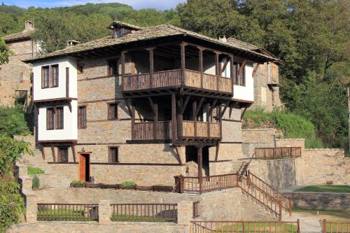 an old building with a balcony on top of it at Дренковите Къщи Drenkovi Houses in Kovačevica
