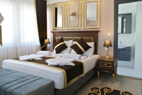 a bedroom with a large bed with towels on it at Emirhan Guesthouse & Suites in Istanbul