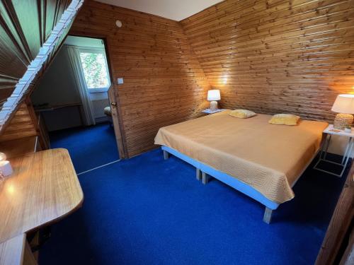 um quarto com uma cama num quarto de madeira em Ubytování Čeladná em Čeladná