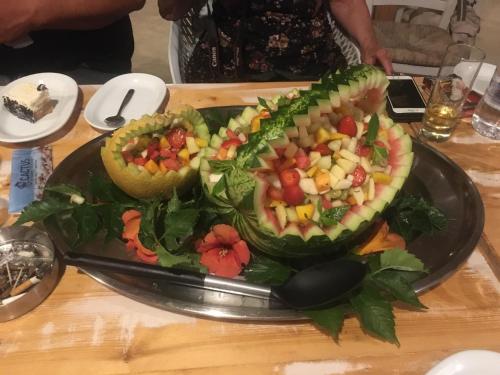 a plate of fruit salad on a table at Cactus Beach Paros in Logaras