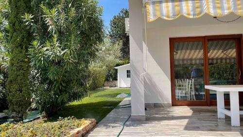 a house with a wooden door and a yard at Holiday home in Isola Albarella 42378 in Isola Albarella