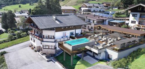 an aerial view of a house with a swimming pool at The Poolhouse Boutique Lodge in Saalbach Hinterglemm