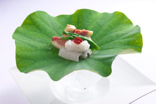 a piece of food sitting on a green leaf at GRAND NIKKO AWAJI in Awaji