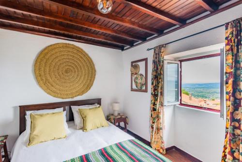 a bedroom with a bed and a window at Casa das 10 Janelas @ Monsanto in Monsanto
