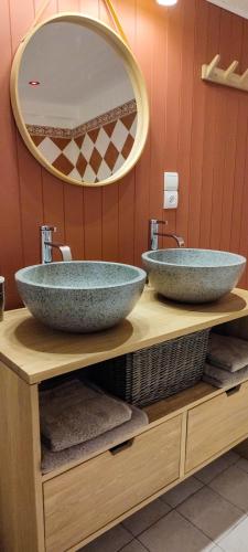 a bathroom with two large bowls on a counter with a mirror at Le Mas Fraissinet in Saint-Jean-de-Valériscle