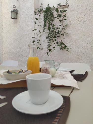 a table with a plate and a cup of orange juice at Casa Rural Casa Sagasta in Elche de la Sierra