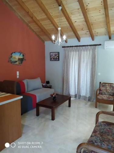 a living room with a couch and a table at Olga's Apartments in Ágios Dimítrios