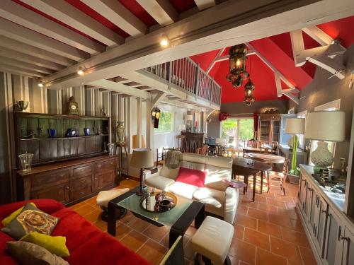 a living room with a couch and a table at LA FONTAINE ROMY in Genneville