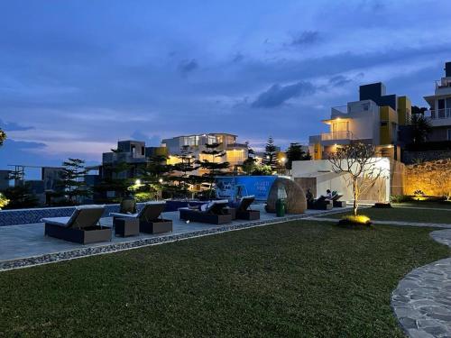 a row of couches in a park at night at Valle Verde Villas in Bandung