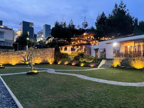 a garden with a tree in the middle of a building at Valle Verde Villas in Bandung