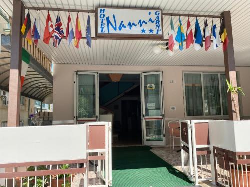 a building with flags on the front of it at Hotel Nanni Garnì in Rimini