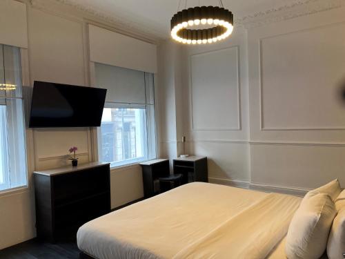 a bedroom with a bed and a tv at The Z Hotel Covent Garden in London