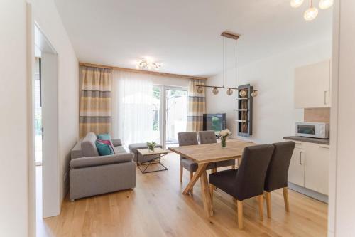 a kitchen and dining room with a table and chairs at Apartments Oasis Wörthersee neu & zentral in Krumpendorf am Wörthersee
