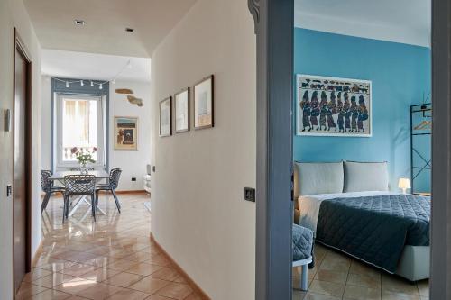 a bedroom with a bed and a dining room with a table at Anna Homestay Bergamo in Bergamo