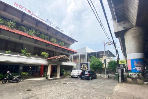 a parking lot in front of a building at Urbanview Hotel Mroom PH in Jakarta
