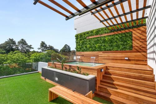 a garden with a hot tub and a patio at The Monroe Luxury Apartments in Johannesburg