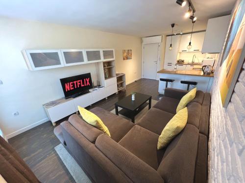 a living room with a couch and a kitchen at Unique Luxurious Jacuzzi PENTHOUSE DUPLEX in City Center! 2 BATHS! FREE PARKING! in Sofia