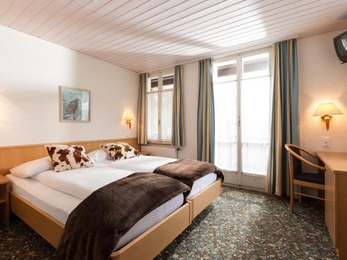 Posteľ alebo postele v izbe v ubytovaní Hotel Oberland