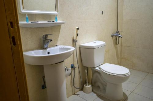 a bathroom with a toilet and a sink at Quiet Rooms 1 Serviced Apartments in Riyadh