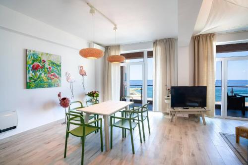 a living room with a table and chairs and the ocean at Rezident Eforie Nord in Eforie Nord