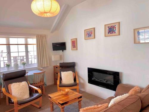 a living room with a couch and a fireplace at Large property which is all about location, location , location ! Lovely Comfortable 2 bedroom flat which is spacious and one of the best value properties of this size so close to the sea , beaches and restaurants 1 min to the sea ! in Lyme Regis