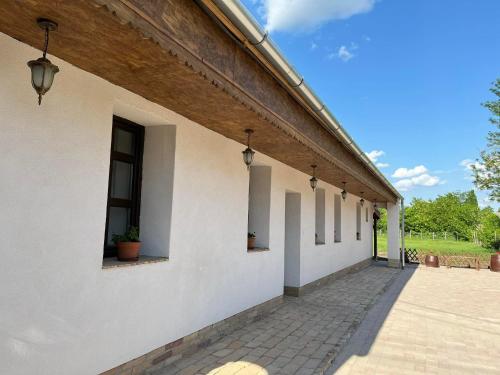 a white building with a row of windows at Kisdió Vendégház in Dég