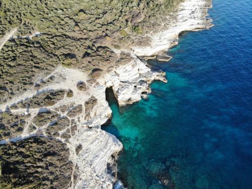 an aerial view of a beach with blue water at Luxury apartment Grotta with sea view and swimming pool in Premantura