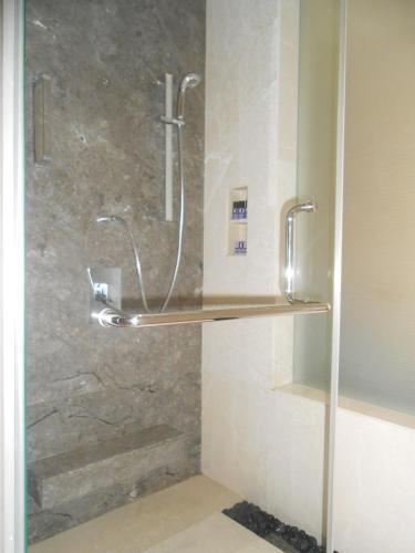 a shower with a glass door in a bathroom at The Lalit Great Eastern Kolkata in Kolkata