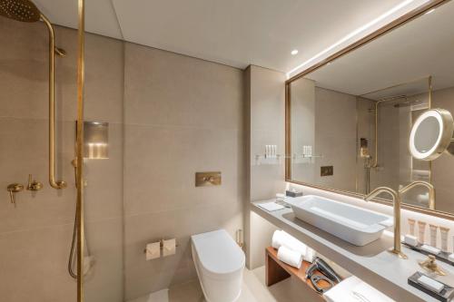 a bathroom with a sink and a mirror at Grand Hotel Açores Atlântico in Ponta Delgada