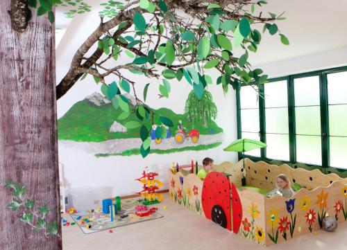 a childrens play room with a tree and toys at Wimmerhof in Höslwang