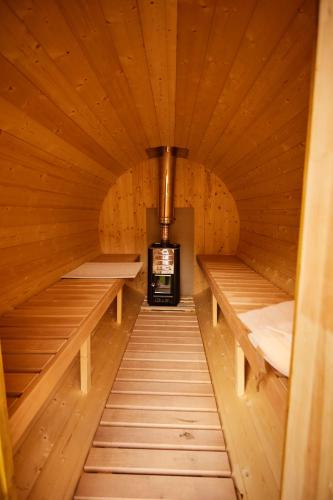 a wooden sauna with two beds and a stove at Complex Butoaiele Transilvaniei - Cazare & SPA - Natura - Relaxare in Mediaş