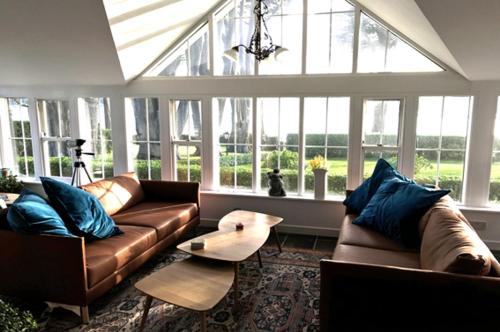 a living room with two leather couches and a table at Lisheen House in Cork