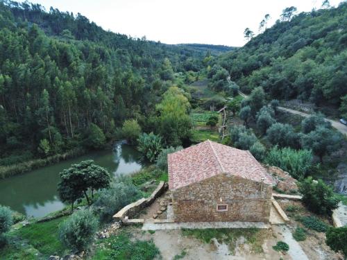 an aerial view of a building next to a river at Beija Rio Charming House in Ferreira do Zêzere