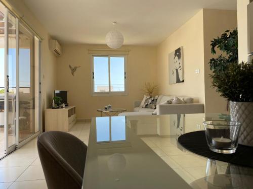 a living room with a couch and a table at Pyla Palms A1 204 in Pyla