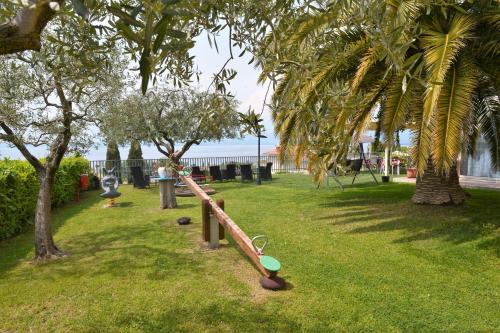a park with a playground with palm trees at Hotel Panoramica in Bardolino