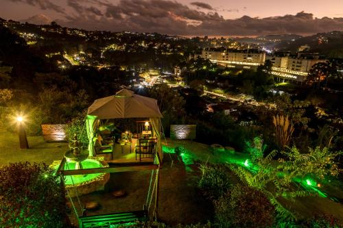 a view of a city at night with green lights at Casablanca Hotel Boutique in Campos do Jordão