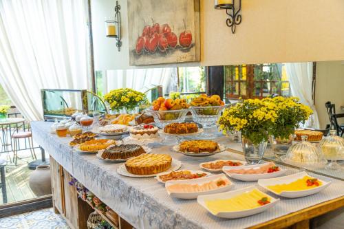 a table with many different types of food on it at Casablanca Hotel Boutique in Campos do Jordão