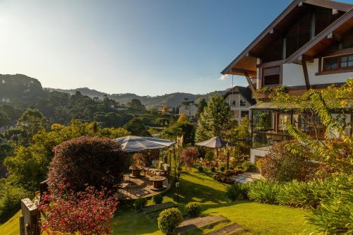 a view of a house with a garden at Casablanca Hotel Boutique in Campos do Jordão