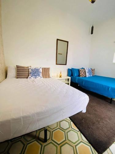 a bedroom with a large bed and a blue couch at house rose in Marrakech