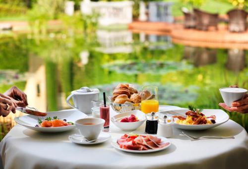 a table with a breakfast of breakfast foods and drinks at Giardino Ascona in Ascona