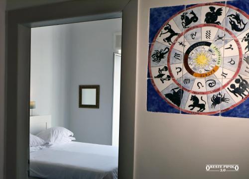 a bedroom with a clock on the wall next to a bed at Jazz Hotel in Naples