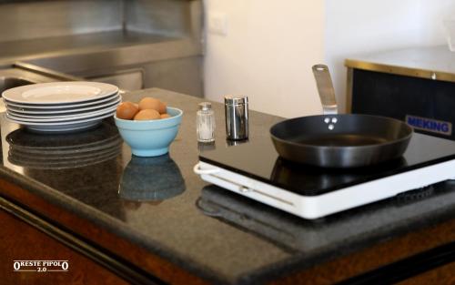 a kitchen counter with plates and a bowl of eggs and a tablet at Jazz Hotel in Naples