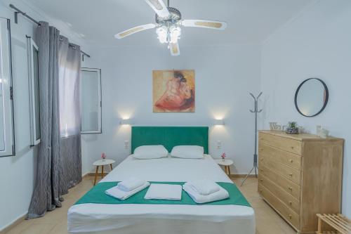 a bedroom with a bed and a ceiling fan at Flora's Apartment! in Zakynthos Town