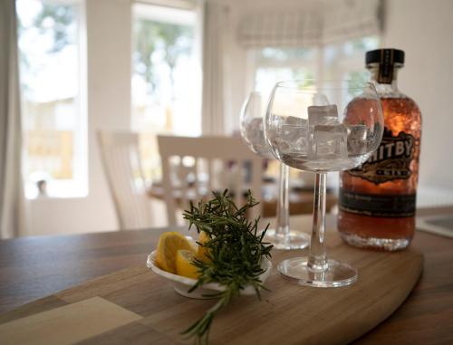 a bottle of whiskey and a wine glass on a table at Hollicarrs - Long Lane Lodge in York