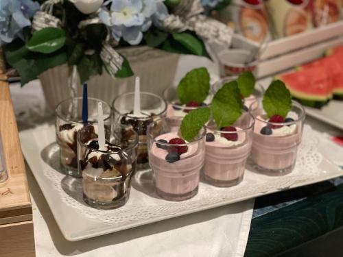 a tray with desserts in glasses on a table at Penzion u Vlčků in Cheb