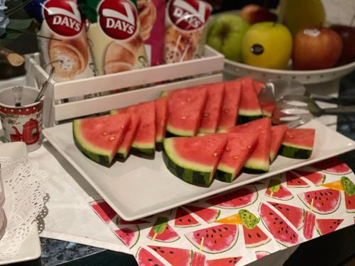a plate with slices of watermelon on a table at Penzion u Vlčků in Cheb
