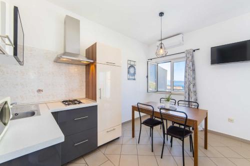 a kitchen and dining room with a table and chairs at Apartments Tilda in Brist